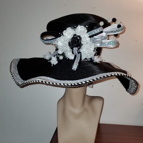Women\'s Black Wide brim hat with silver and black and white trim and a accent.